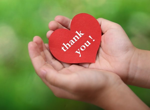 child holding heart with words - thank you