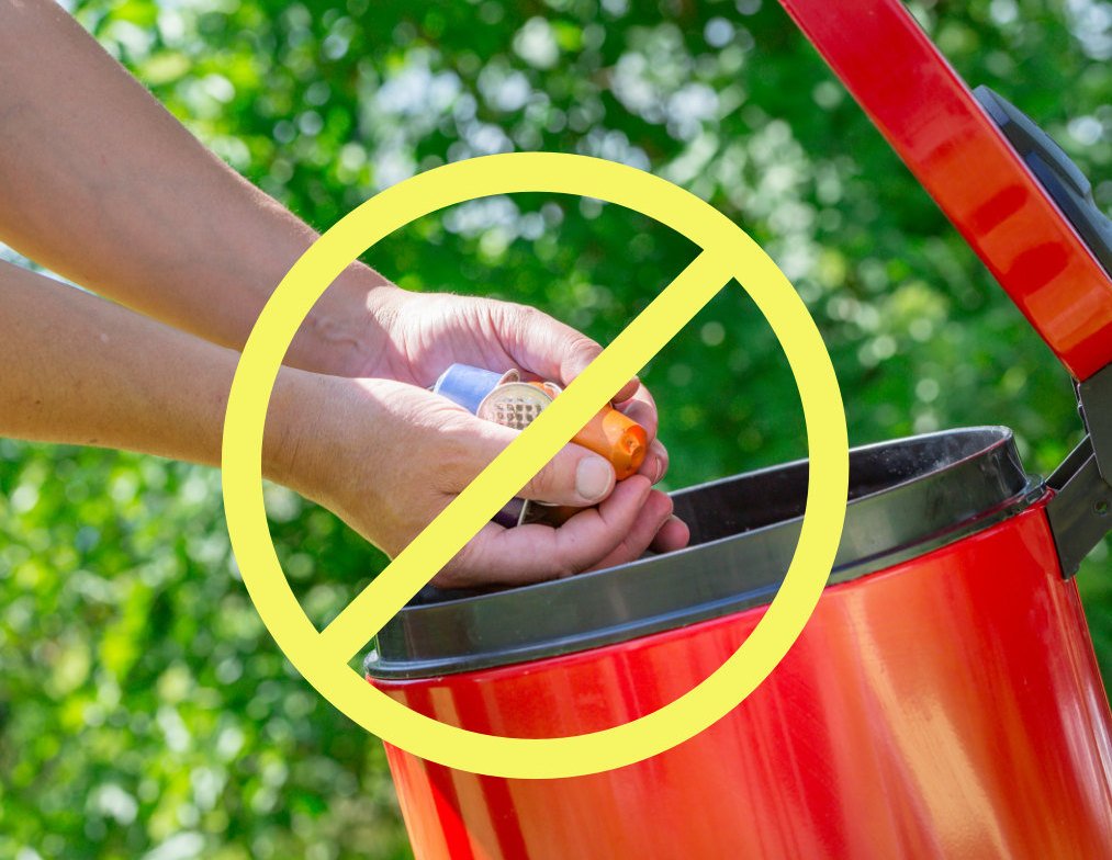 hands throwing used Nespresso coffee capsules into bin with 'ban' symbol